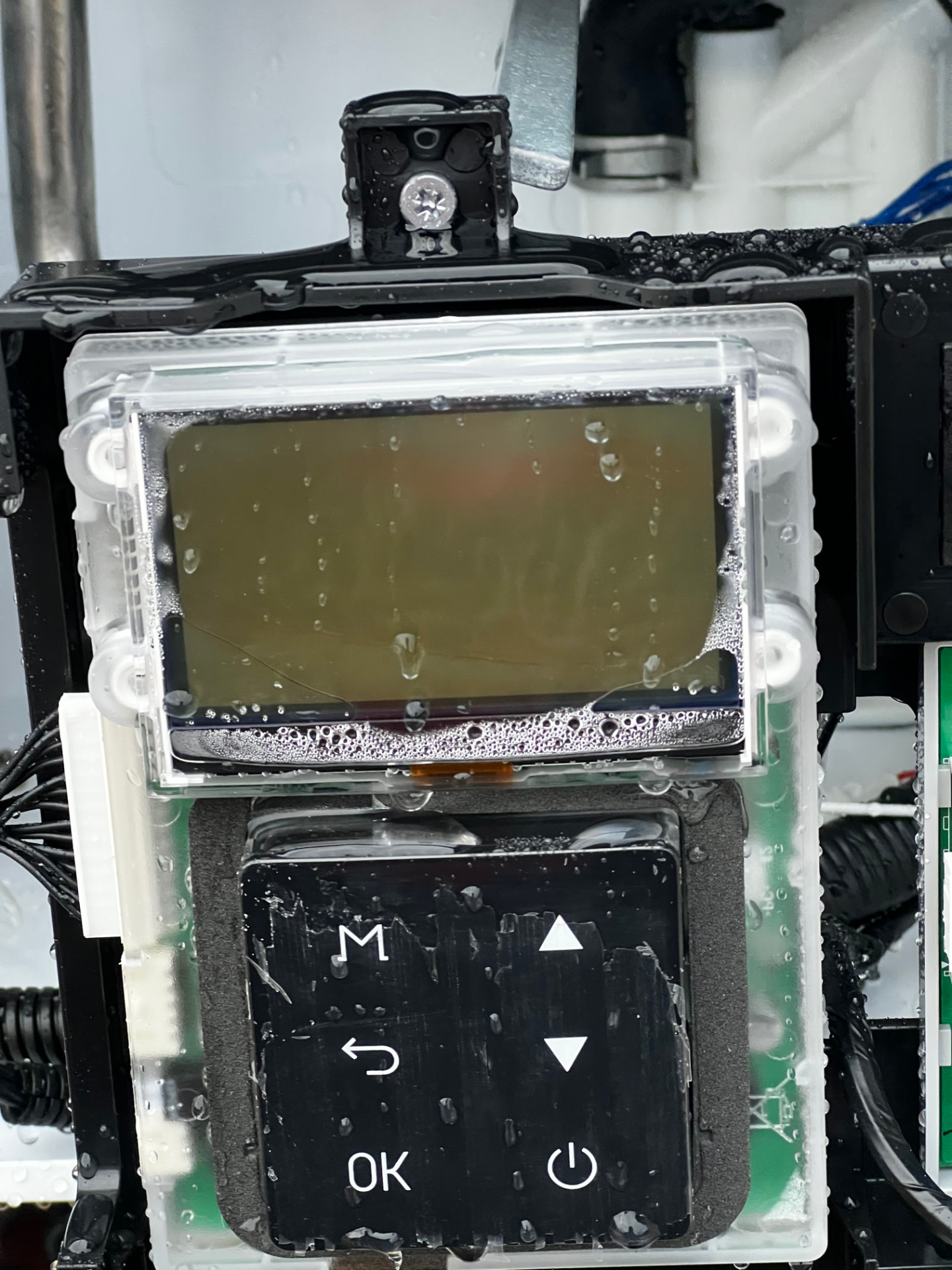 Tankless water heater control board and digital display during installation service in Gadsden, Alabama